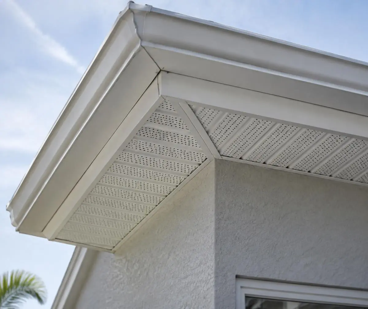 White soffit and fascia under the roof edge of a stucco Florida home